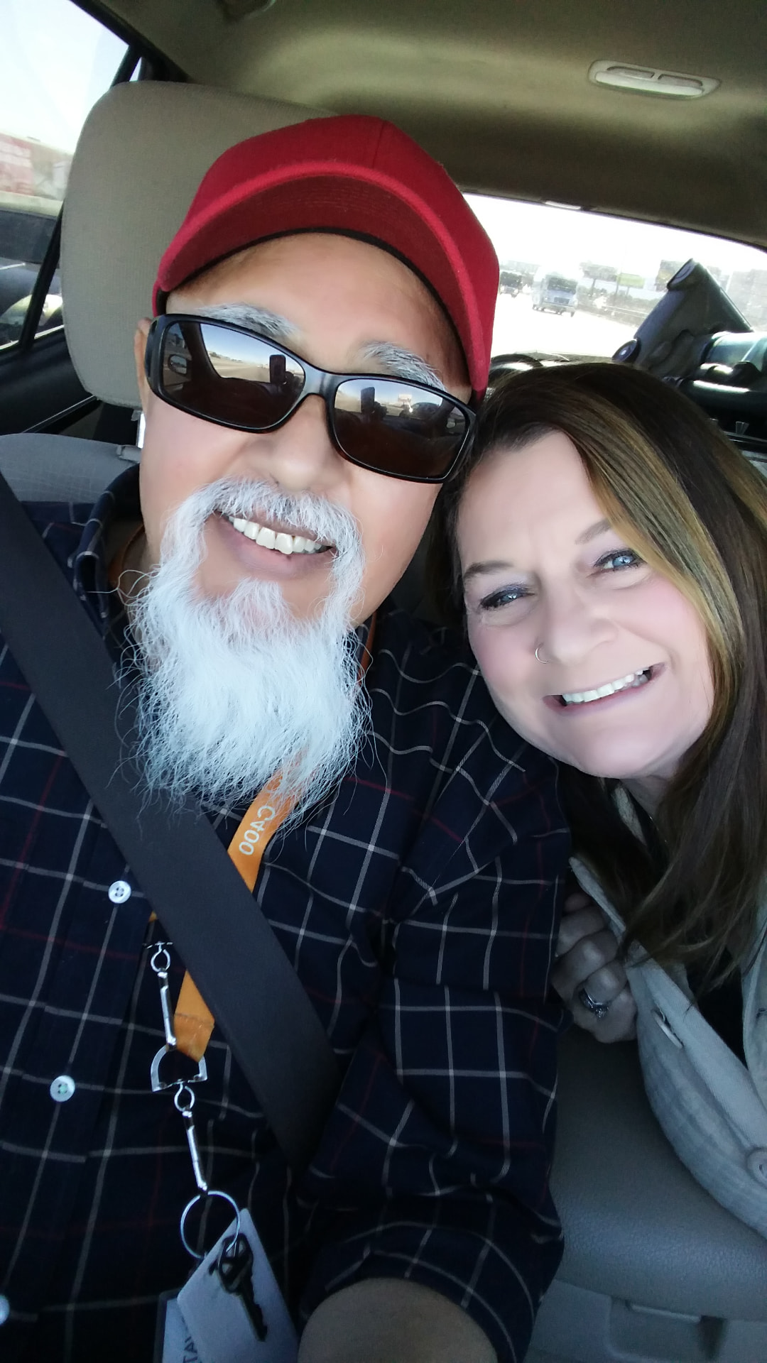 Laurie and Raul laughing together on the road to a gig