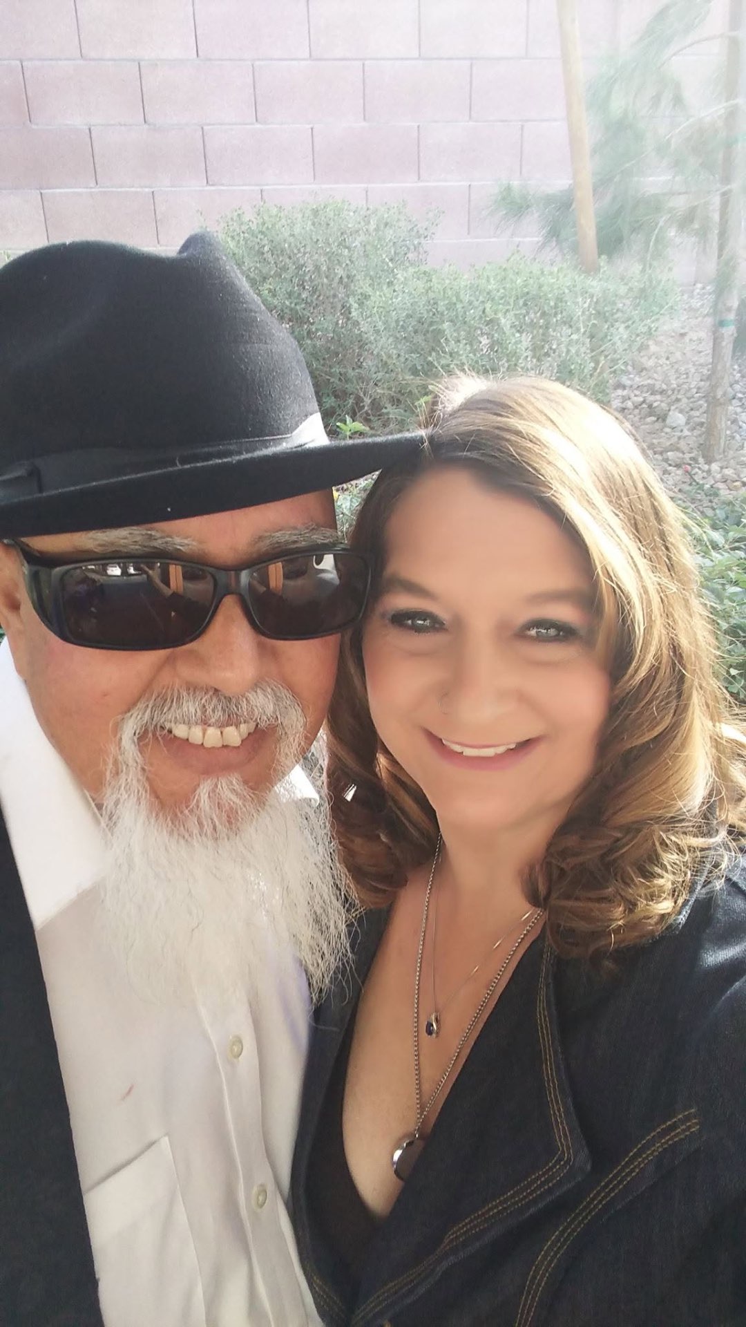 Laurie and Raul of Leather & Lace smiling together outdoors